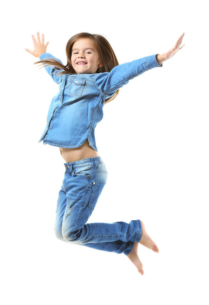 Cheerful little girl jumping  - Valokuva, kuva