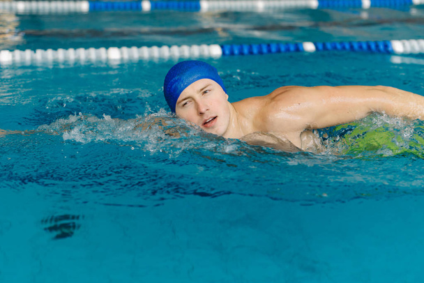 close up photo of young sportsman swimming in pool - Photo, Image