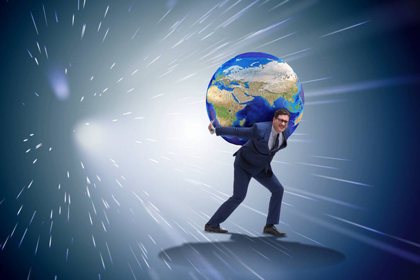 Businessman carrying Earth on his shoulders - Foto, Bild