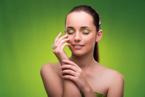 Young woman in beauty concept on green background - Foto, Bild