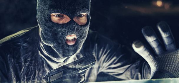 Masked burglar with pistol gun - Foto, afbeelding