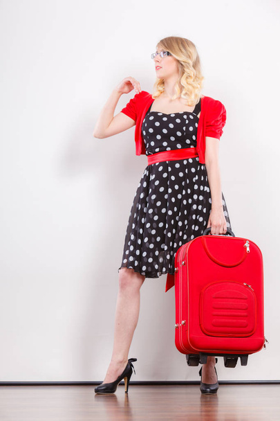 Elegant fashion woman with red suitcase - Foto, Imagen