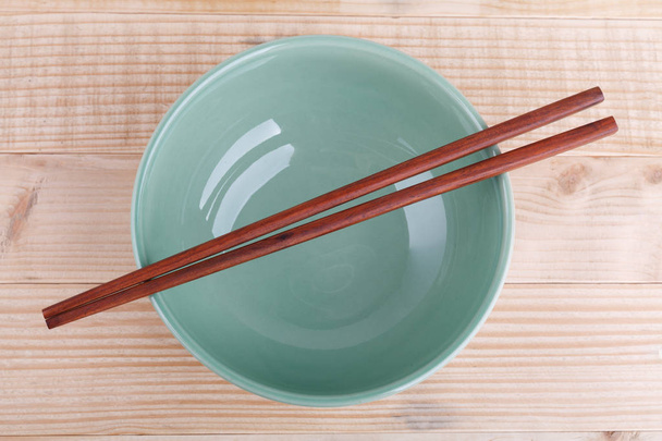 Chopsticks in asian set table on wood background - Photo, Image