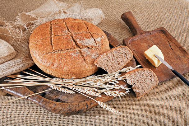Decoration  with round integral bread on wooden board, note shallow depth of field - Photo, Image