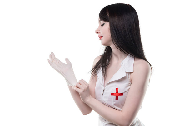 Brunette nurse wearing medical glove - Photo, Image