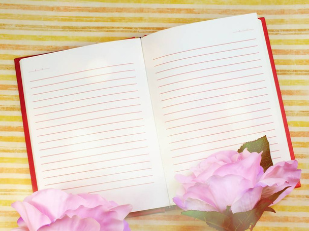 top view of blank sheet of notebook and beautiful bouquet flowers - Фото, зображення