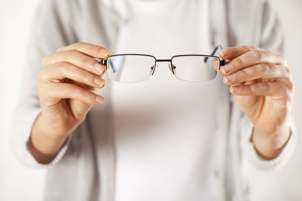 Woman hands holding eyeglasses - Foto, Imagem