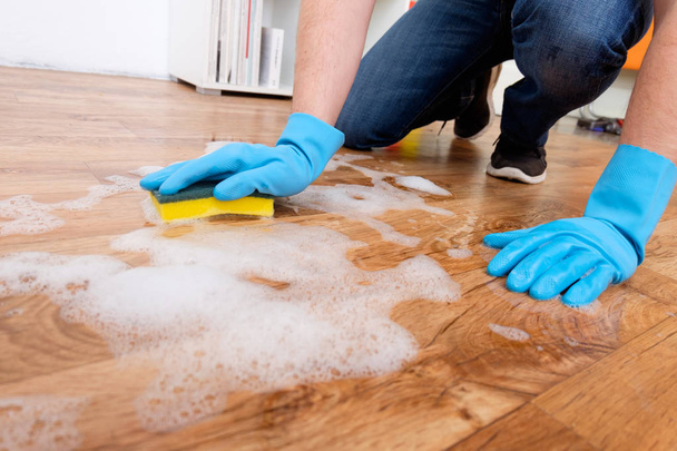 Cleaning a parquet floor with foam on the floor - Photo, Image