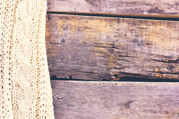 knitted plaid, sweater on old wooden boards - Foto, imagen