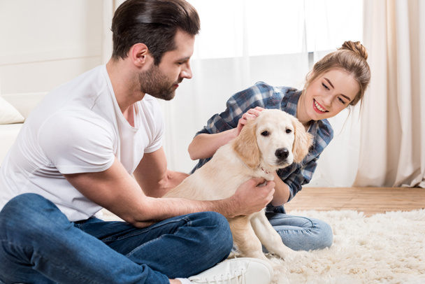 Young couple with puppy - Foto, Imagen