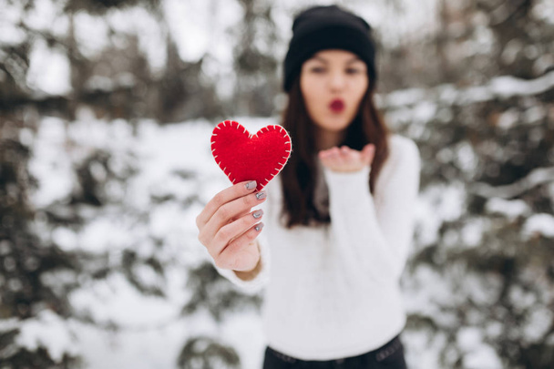 Girl holding heart in winter nature - Fotó, kép