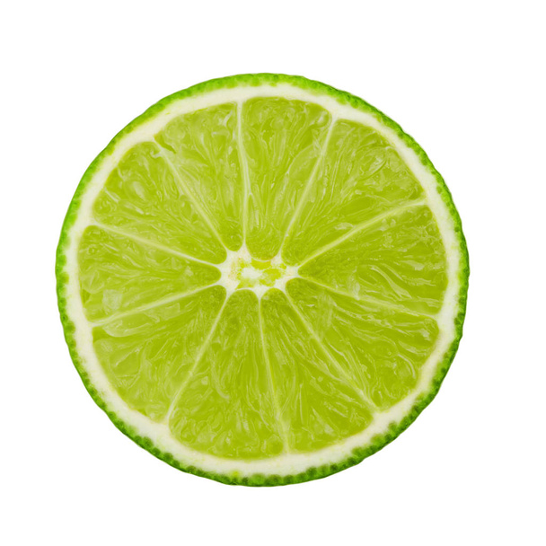 Lime fruit and a slice isolated on white background - Foto, afbeelding