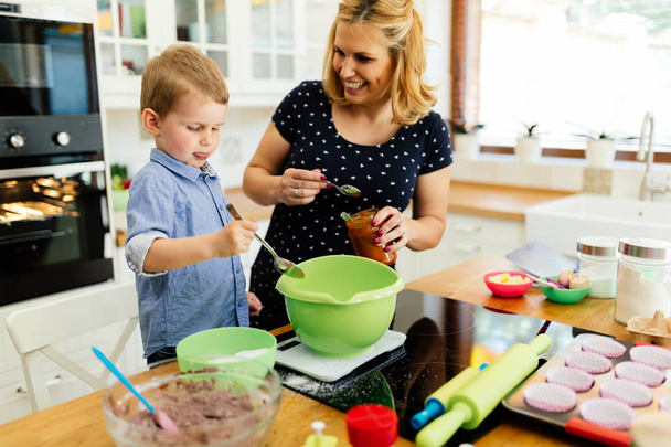Child helping mother bake cookies - Photo, Image