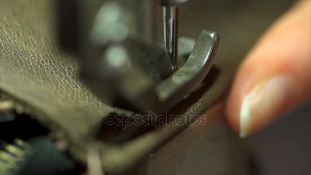 Slow motion of woman hand stitching piece of leather with vintage sewing machine - Footage, Video