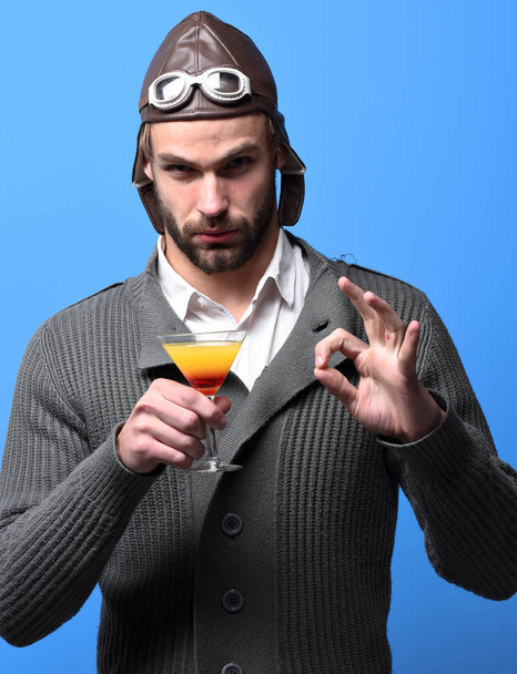 bearded pilot with cocktail in glass - Photo, image