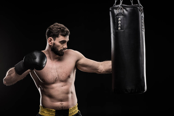 Boxer with punching bag  - Foto, afbeelding