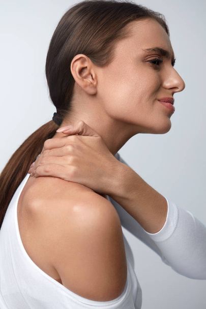Pain In Body. Beautiful Woman Feeling Pain In Neck And Shoulders - Foto, afbeelding