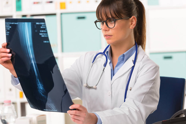 Female doctor looking at patients x-ray - Photo, Image