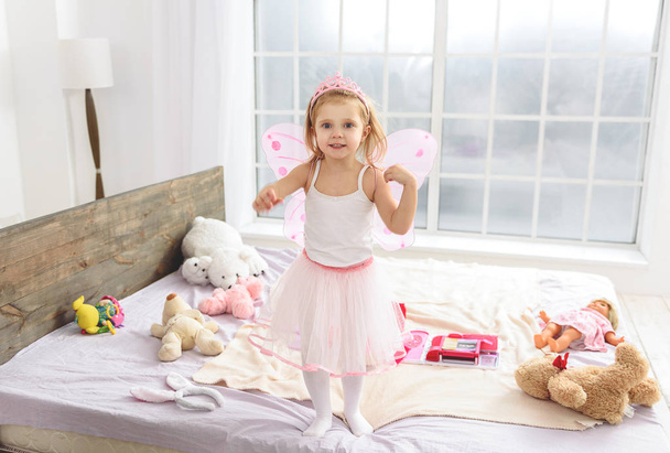 Cute small princess playing in bedroom - Foto, imagen