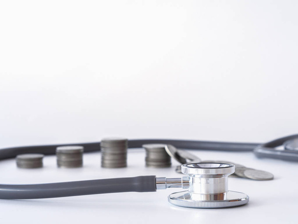 Stethoscope and coin stack on white background. money for health care, Financial Aid, concept. - Foto, Bild