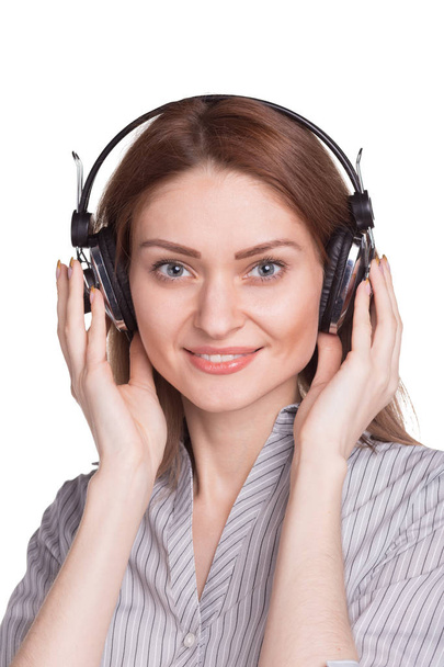 Happy young woman listening to music via headphones - Foto, Imagen