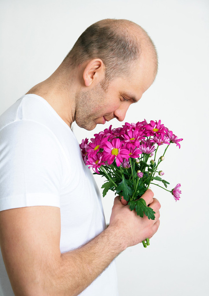 man with flowers - Фото, изображение