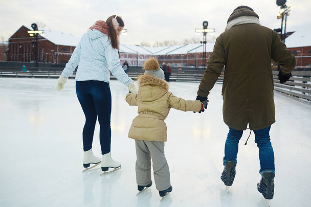 Family on skating-rink - Fotoğraf, Görsel