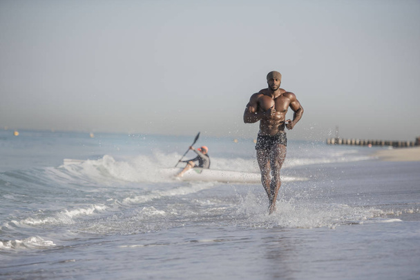 man running on edge of beach - Photo, Image
