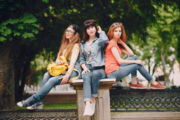 three young girls walking in the park - 写真・画像