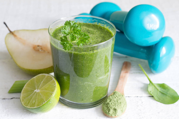 Green smoothie and dumbbells health diet lifestyle concept - Фото, зображення