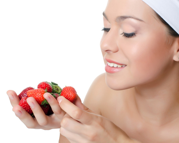 The beautiful woman with a strawberry - Foto, Bild