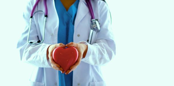 Doctor with stethoscope holding heart, isolated on white  background - Photo, Image