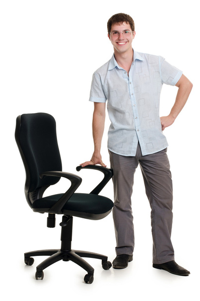 The businessman stands an armchair isolated - Zdjęcie, obraz