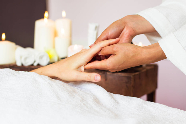 Woman receiving a hand massage at the health spa.  - Fotó, kép