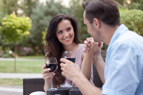 Romantic couple having red wine - Фото, изображение