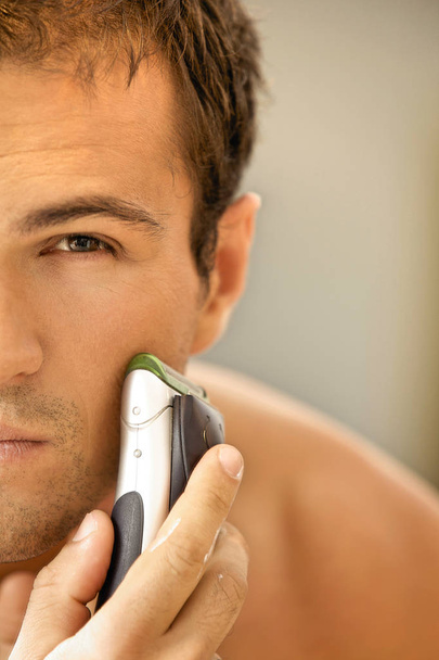 man shaving with electric shaver - Photo, Image