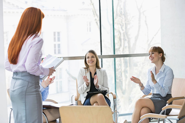 Happy businesswomen clapping for colleague - Photo, Image