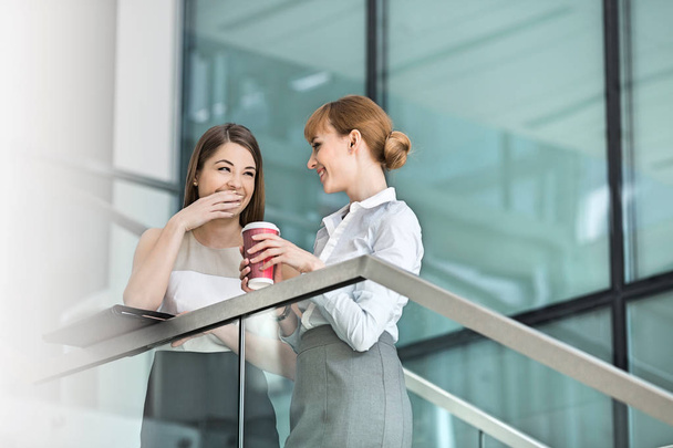 Businesswomen gossiping while having coffee - Valokuva, kuva