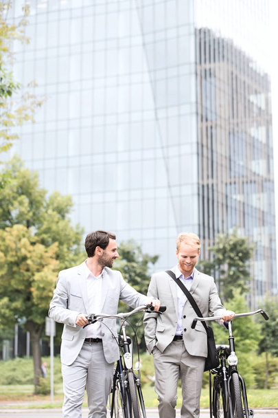 Businessmen with bicycles walking - Foto, Bild
