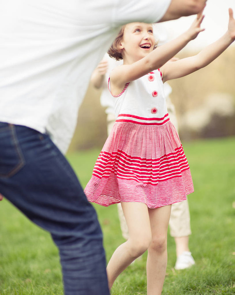 Parents with daughter throwing ball  - Foto, imagen