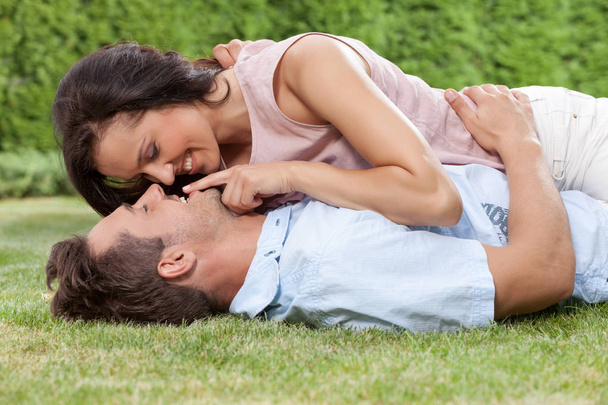 woman touching man's lips while lying - Foto, afbeelding