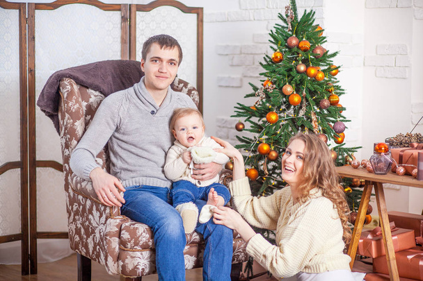 Happy family in jeans sitting xmas tree anticipation new year - Fotó, kép