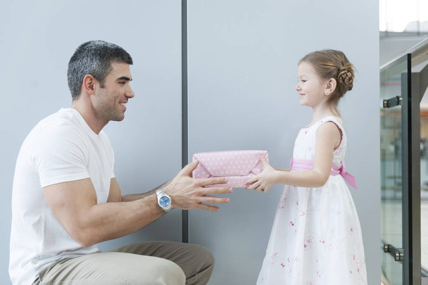 Girl gives present to father  - Zdjęcie, obraz