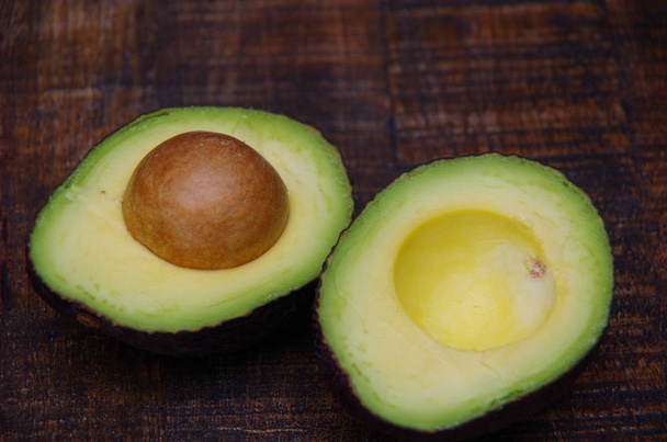 Two halves of avocado with a grain - Photo, Image