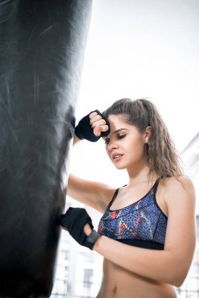 Beautiful woman with boxing bag - Photo, image