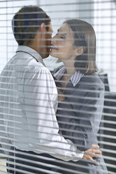 Businesswoman about to kiss businessman  - Foto, Imagen
