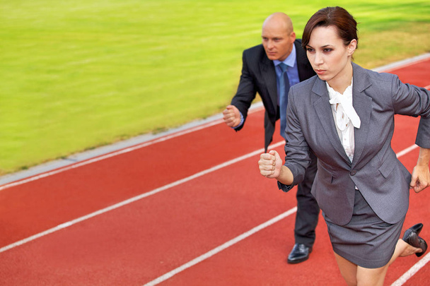 Businessman and woman on race track - Zdjęcie, obraz
