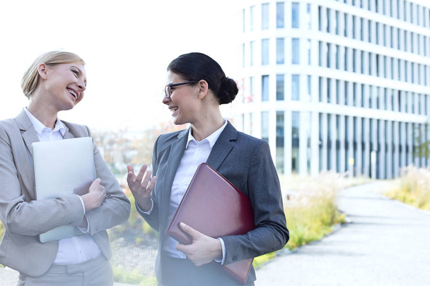 Cheerful businesswomen conversing - Fotó, kép