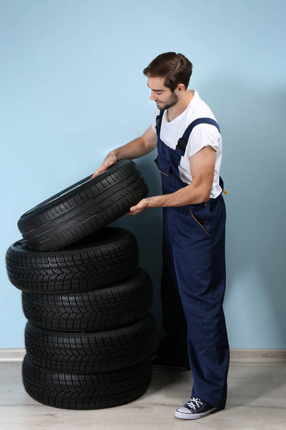 Young mechanic with wheels  - Valokuva, kuva