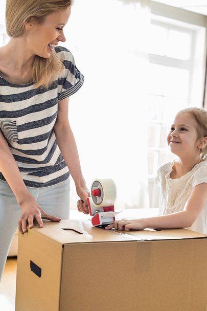 Mother and daughter packing cardboard box  - 写真・画像